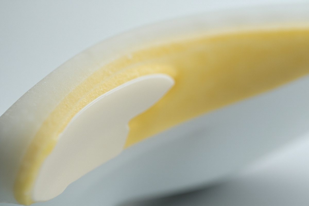 Close-up of a plain white rubber midsole with one area yellowed and another still pale.