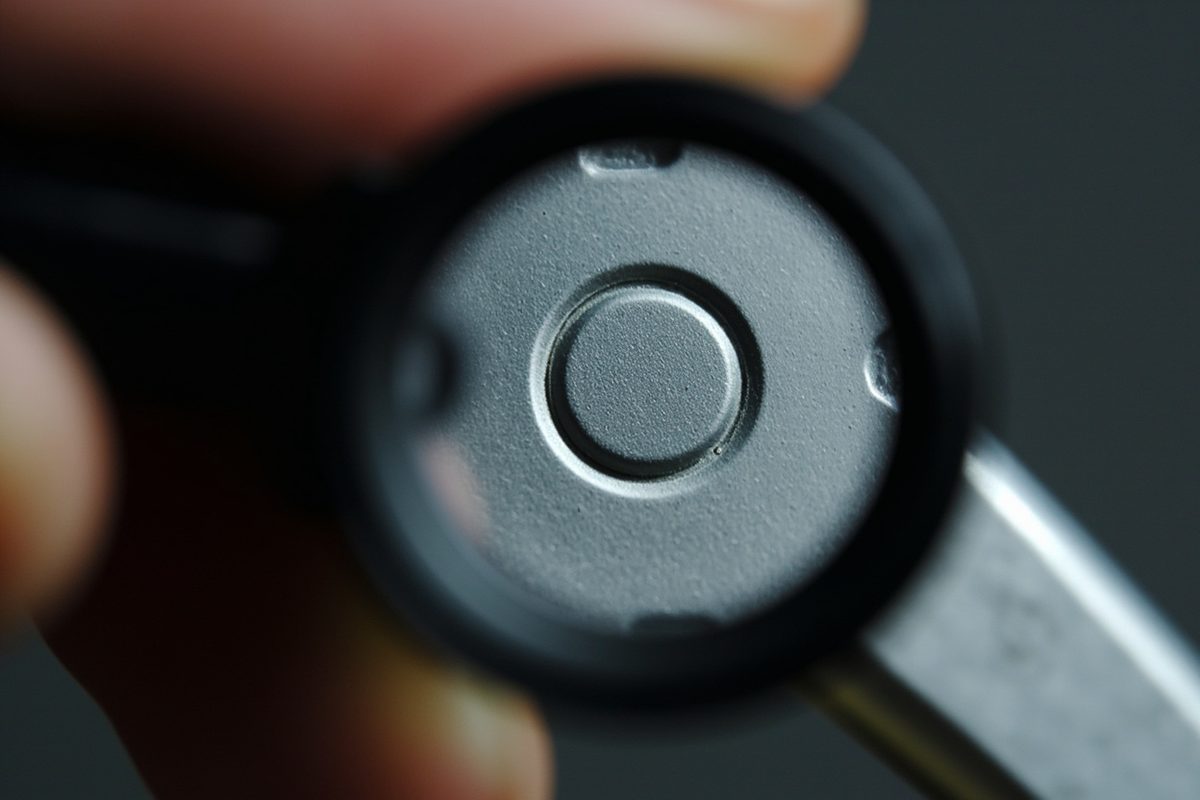 Extreme close-up of a recessed blank stamp panel on the back of a plastic figure leg under a magnifier.