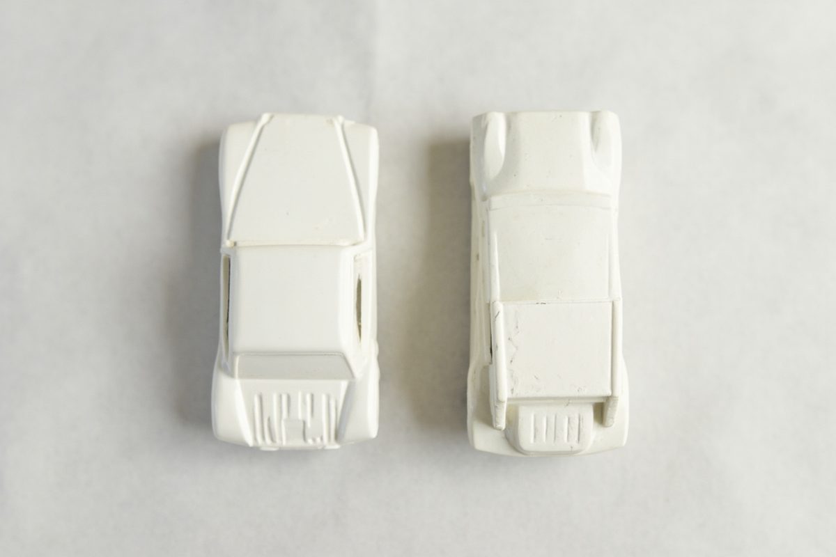 Two blank diecast car bodies side by side, one smooth and one subtly textured.